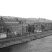 Scanned image of photograph showing view from SW showing SSE front (Mansfield Road front) of mills with numbers 3-15 in background