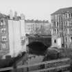 View from W showing WNW front of bridge with tenement on left and part of 254-276 Kilmarnock Road on right