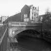 View from SW showing SSW front of bridge with tenement in background