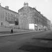 General view from SW showing part of WSW front of works with tenements on right
