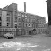 View from SW showing SSW front of main block of mill with part of tenement on left