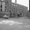 View from SW showing SSW front of main block of mill with part of tenement on left