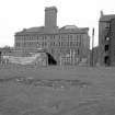 View from W showing part of WNW front of mill with tenement on right