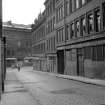 View from NE showing ESE front of warehouse with part of numbers 7-13 Shuttle Street on right and numbers 43-61 Ingram Street in background