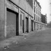 General view from NW showing WSW front (Greenhead Street front) of works with part of electricity substation in foreground