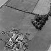 Oblique aerial view of Redden centred on the remains of a grange with a farmsteading adjacent, taken from the NNE