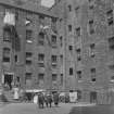 General view of Milne's Court, Edinburgh, with children standing in the centre.