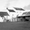 View from W showing WSW front of main block with kiln and dwellinghouse on left and part of stores on right