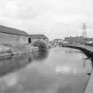 View looking ESE showing SSW front and part of WNW front of W block of foundry with canal on right