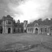 Argyll, Poltalloch House.
General view of entrance fromt and stables facade from South-East.