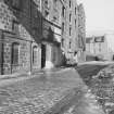 View from S showing part of ESE front of main building with brick extension of flour mills and tenement in background