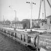 View from SE showing harbour signals on lock with part of sheer legs on right