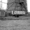 View from ENE showing part of SE and NE fronts of wooden cooling tower with wagon in foreground
