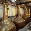 Bowmore Distillery
Interior view within still house showing the four copper pot stills, all of which are heated by steam coils