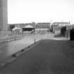 View looking ESE showing part of SW front of warehouse with part of sawmill in background