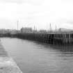 View looking NE along entrance channel of numbers 1 and 2 docks with W pier of wave basin on right and dock gate on left
