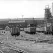 General view from NE showing NE front of colliery buildings with trucks in foreground