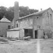 View from ENE showing ESE front and part of NNE front of main block with kiln on left
