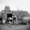 View of small stove between kiln and drying shed, coals used to light kiln.
Digital image of B 9481/12