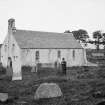 General view from North-East with man standing in graveyard.