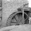 View of waterwheel with figure.
Digital image of AG 291.