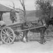 Photographic copy of photo taken before 1940, showing Mr McIntosh (miller) with sack barrow, and his father-in-law, Mr George Milne on cart.
