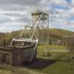 View showing surviving headframe of Highhouse Colliery, associated winding engine house, and surrounding bings.  The remains of the mine now form part of an industrial estate