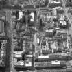Oblique aerial view of Cowgate and surrounding area, including Chambers Street to left of photograph, George IV Bridge at top, High Street to right and South Bridge at bottom