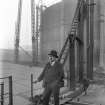 General view of the engineer for the reconstruction of Number 4 gas holder standing beside uninflated gas holder.