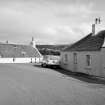 View from WNW showing two single storey cottages