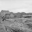 View from NNE showing boat yard wooden buildings and concrete slip