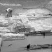 General view of timber beams and remains of sluice of watermill , during excavations by Brian Hope-Taylor. 
