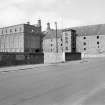 View from SE showing SSW and ESE fronts of E bay wing with castellated hoist block and central silo block
