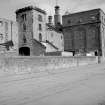 View from W showing SSW and WNW fronts of W bay wing castellated hoist block and silo block