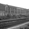 View from N showing NW and NE fronts of agricultural factory with part of Dennistoun Tram Depot in foreground
