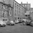 View from SSE showing part of E and SSE fronts of block now used as a garage