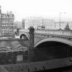 View from SSE showing WSW front of North Bridge, with part of W end of Waverly Station in foreground, North British Hotel in left background and GPO building in right background
