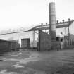 View from SW showing chimney at W end of MacDowall Street N buildings