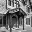 Detail of main entrance porch with rustic tree columns, stickwork and decorative bargeboards
Digital image of D/11001