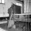 Interior
View showing men erecting mash tun in engineering shop
