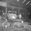 Interior
View showing men pouring iron in light moulding shop