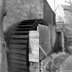 View from E showing waterwheel on NNE front