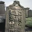 View of gravestone depicting a mother and children, 1765.