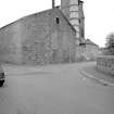View from SE showing parts of ESE and SSW fronts of retort house with chimney