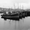 View from SSW showing fishing boats moored together on quay