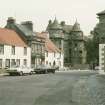 View from SW showing SSE fronts of (left to right) The Saddlers, Post Office and St Andrew House with Palace in background