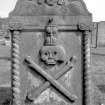 Peebles, Old Town, Old St. Andrew's Church, cemetery.
General view of the headstone of Thomas Hogg. Twisted pilasters with Ionic capitals, with a winged soul in the pediment above. A large skull and crossed bones appear between the pillasters, topped with an hourglass.
Digital image of B 4146/10