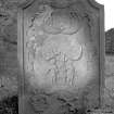 Lagganallachy Churchyard.
General view of gravestone commemorating George Black, 1764. Winged soul, sock and coulter of the plough, Adam and Eve, skull, crossed bones and hourglass.
