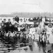 Historic photograph showing general view of school outing at beach.