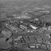 Aerial photograph of a general view of Ravenscraig Steelworks, and surrounding area, including Anderson Boyes, Craigneuk Street, Motherwell from south.  This shows two of the three cooling towers of the Ravenscraig site (right), Scrap Metal Preparation area (with 'white' roof), Stripping and Mould Preparation, North and South Casting Say and Ladle Sevice Bay building left); Coke Ovens and Blast Furnaces beyond with their cooling towers (centre)  and Sinter Plant no. 3 at the north end of the site (top right). The sag tipping, processing and storage areas sit to the north (top).
A separate selective enlargement covers the foreground of the above photograph, and shows Anderson Boyes, Craigneuk Street, Motherwell only.  
The selective enlargement is held in the Motherwell A-C boxfile.